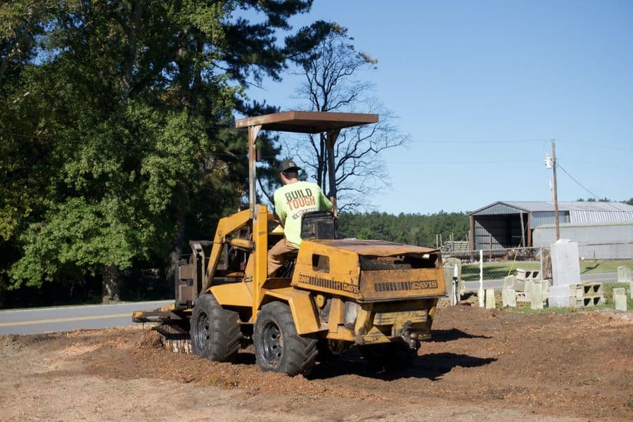 Vermeer stump grinder parked by the farm buildings at the end of the job